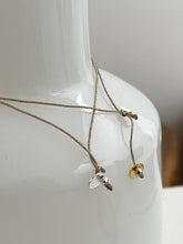 Thick cross bracelet on lurex string